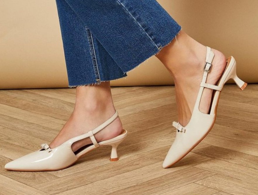 Beige pointed-toe slingback heels from Oasis with a glossy patent-leather finish and a dainty bow detail, perfect for elegant, understated looks.