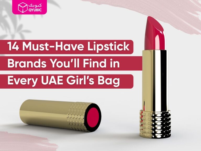 Promotional graphic featuring a bold pink lipstick in a gold tube with the text “14 Must-Have Lipstick Brands You’ll Find in Every UAE Girl’s Bag” in white font over red blocks. The image highlights popular lipstick choices commonly found in makeup bags across the UAE, with branding from QYUBIC in the top left corner.