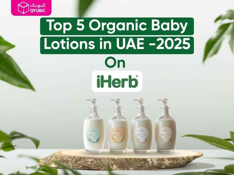 Five elegant glass pump bottles of organic baby lotion displayed on a wooden slice, with ‘Top 5 Organic Baby Lotions in UAE – 2025 on iHerb’ text and QYUBIC logo
