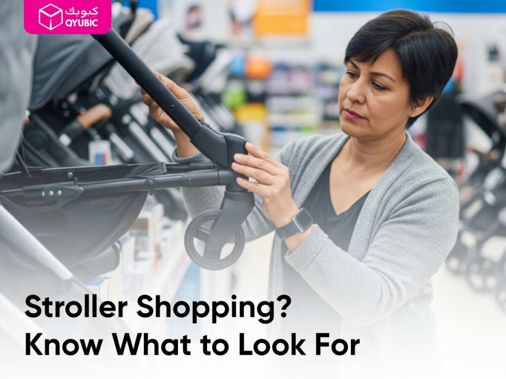 Parent in a bright store aisle inspecting a stroller’s frame and wheel connection up close.