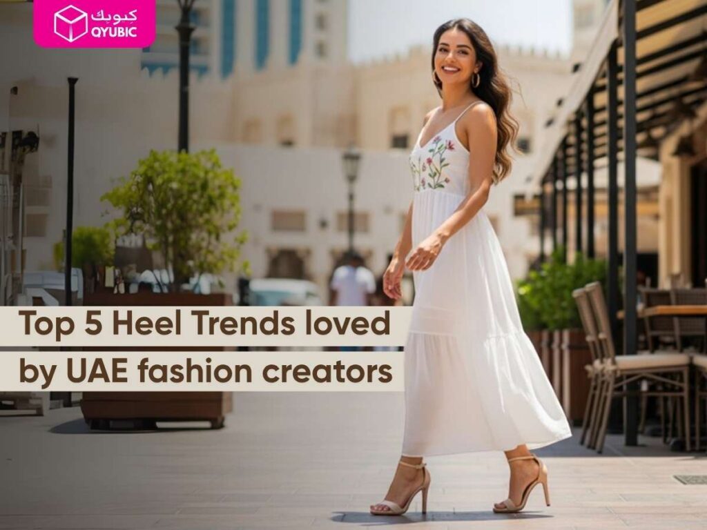 A smiling woman in a white midi dress walking outdoors in nude strappy heels, with text “Top 5 Heel Trends loved by UAE fashion creators” and Qyubic logo highlighting trendy heels.