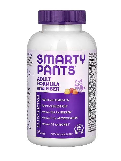 A bottle of SmartyPants Adult Formula + Fiber Gummies, likely showing flavors like lemon, strawberry banana, and orange. The image emphasizes a comprehensive adult multivitamin with Omega-3s and fiber.