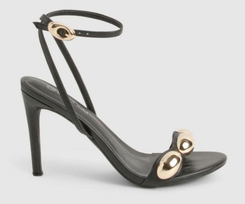 Black high stiletto metal accent heels with metallic hardware detailing and adjustable ankle strap from Boohoo, perfect for elegant night-out looks.