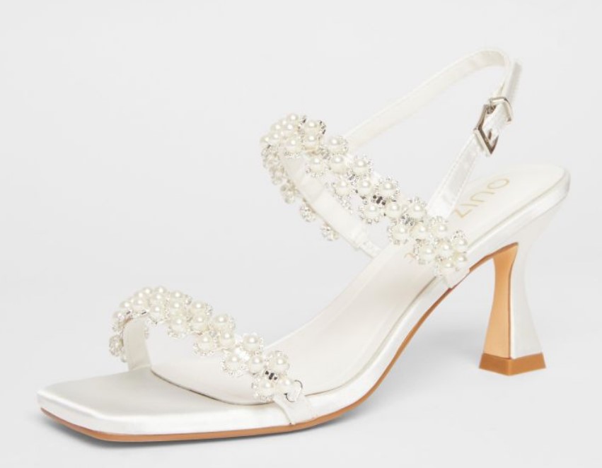 White bridal heels from Quiz with pearl-embellished straps and a flared heel, perfect for elegant wedding or occasion wear.