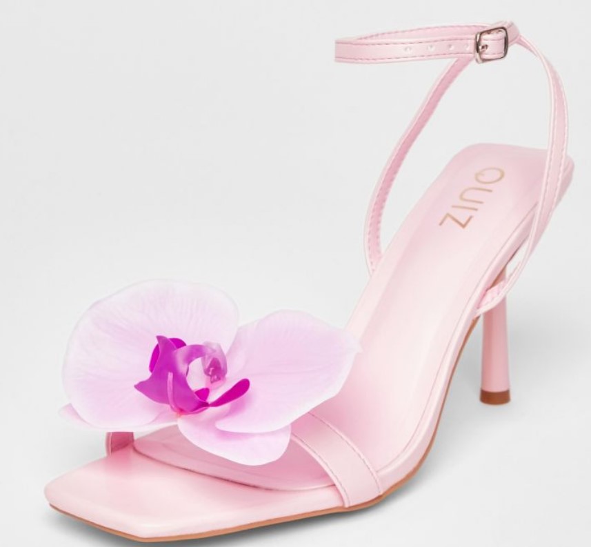 Pink embellished heels from Quiz featuring a bold flower appliqué, perfect for adding a romantic touch to minimalist outfits.