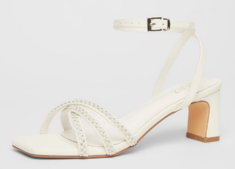 A beautiful wedding embellished white heeled sandal for flat feet with a steady heel height .