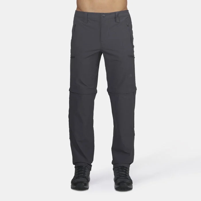 The North Face Exploration Convertible Pants in grey, offering UPF 50 sun protection and water-repellent finish with zip-off legs. An ideal choice for men needing versatile cargo pants or travel cargo pants that convert to shorts.
