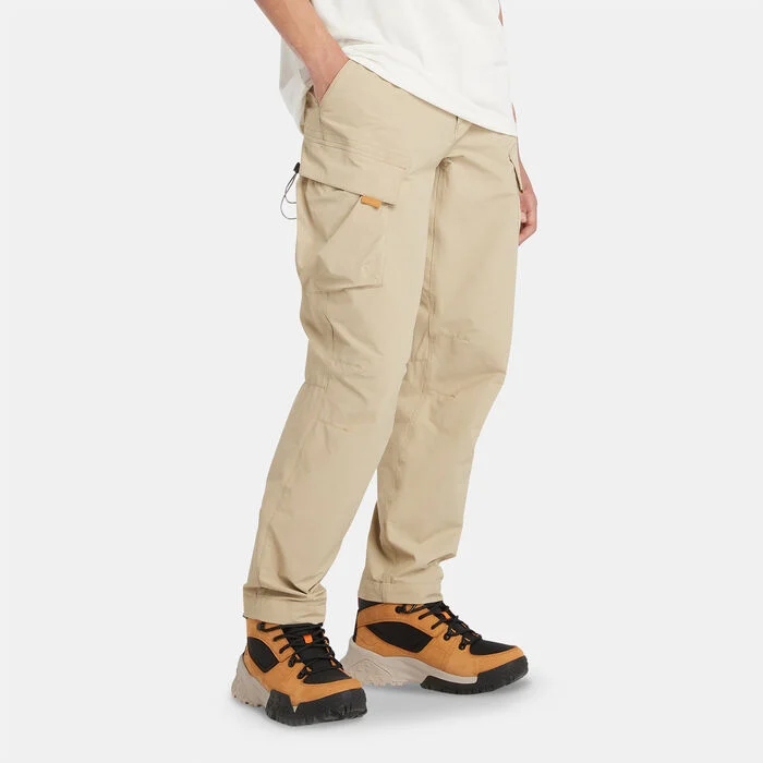 Timberland Men's Baxter Mobi Flex Tech Quick-Dry Stretch Pants in beige, featuring quick-dry waistband and Mobi Flex Tech for enhanced mobility. Ideal for men seeking multifunctional cargo pants or travel cargo pants that stand up to Dubai's heat
