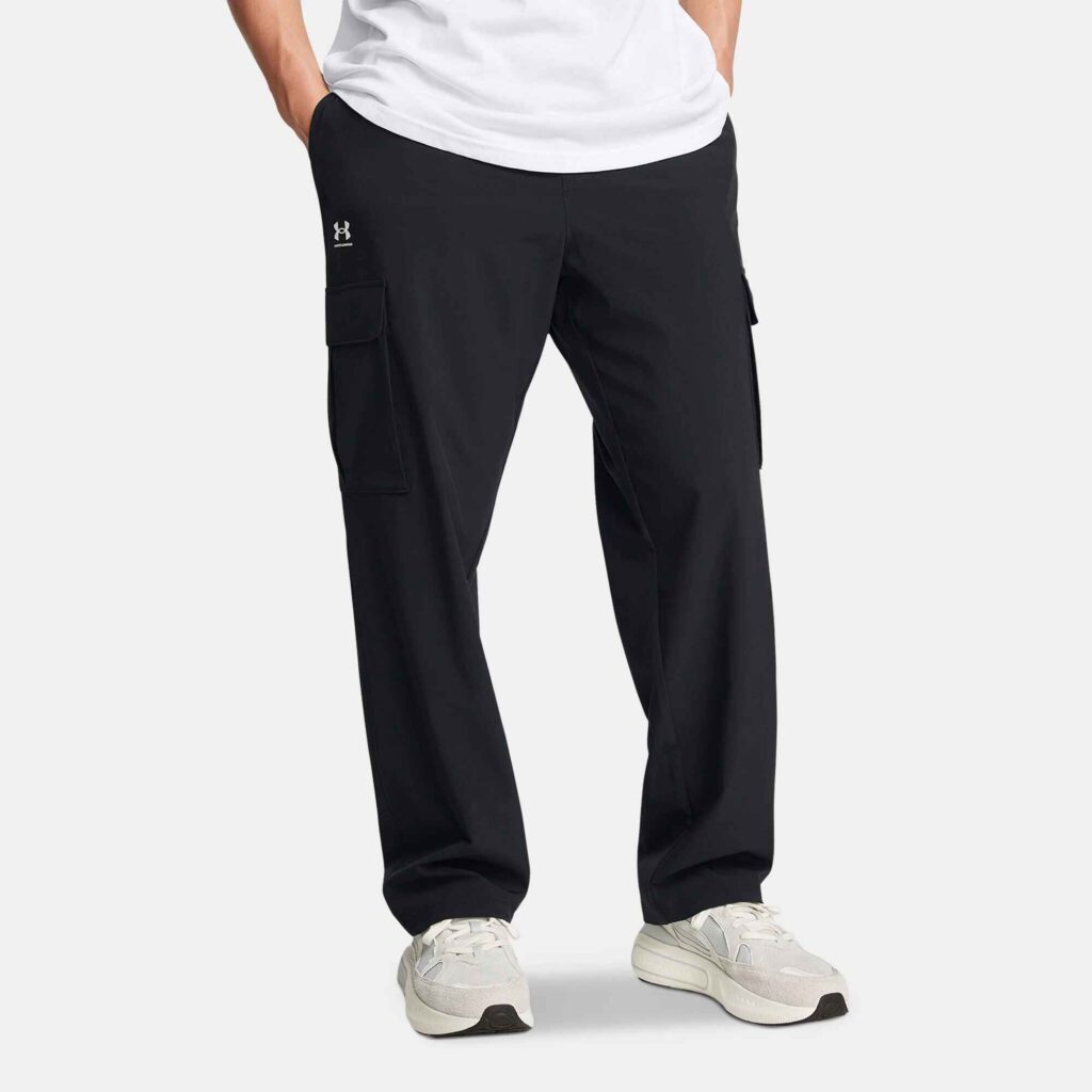 Under Armour Men's Vibe Woven Cargo Pants in black, with UA Storm technology and 4-way stretch, offering a fitted yet comfortable look. Perfect for men seeking stylish streetwear cargo pants or tactical cargo pants for active days in Dubai.