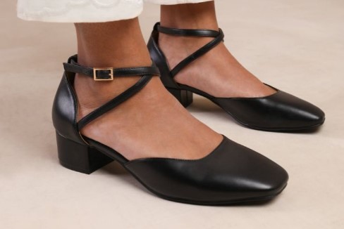 An image showcasing a foot wearing a comfortable heel pump with ankle straps.