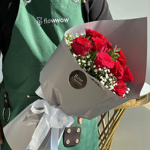 Fresh rose bouquet wrapped in sleek gray paper, with delicate baby's breath, perfect for gifting on anniversaries and special occasions. The stunning red roses symbolize love and affection.