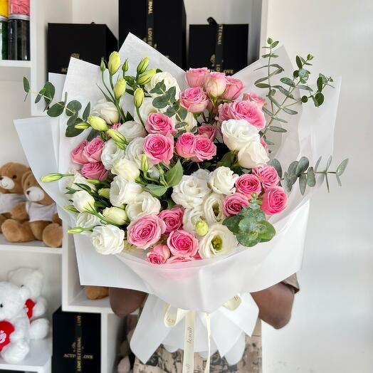 A luxurious bouquet of pink and white roses, elegantly wrapped in white paper. A perfect choice for an anniversary gift that speaks of love, tenderness, and elegance.